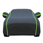 Black waterproof full car cover with green reflective trim, white background, all-weather outdoor car protection
